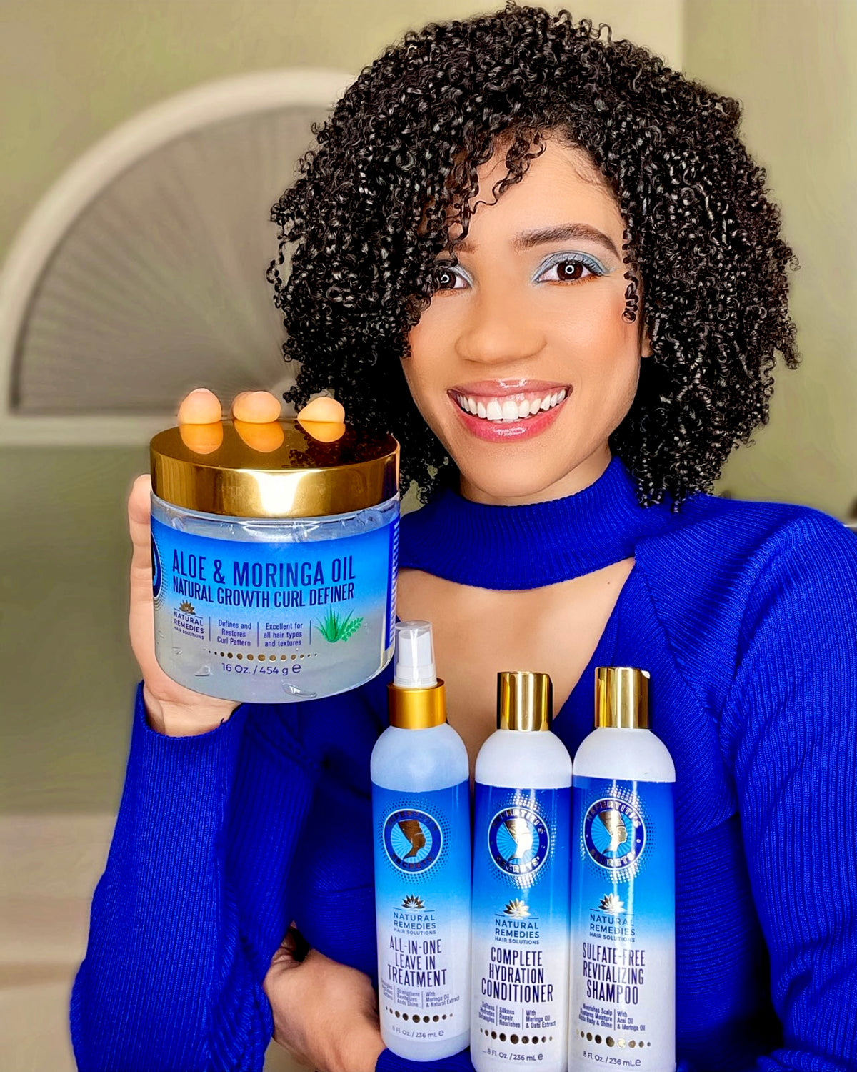Lady in blue dress holding nafertiti&#39;s hair products